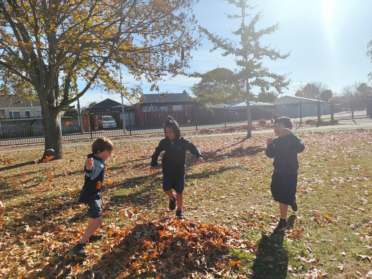 3 Papanui Primary Students playing with leaves