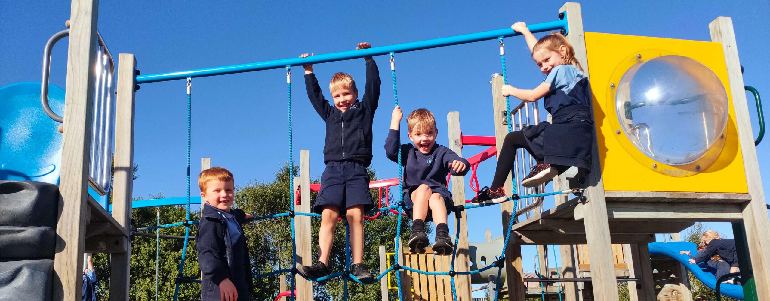 4 Papanui Primary students playing on climbing ropes